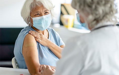 Patient showing her arm for a flu shot.