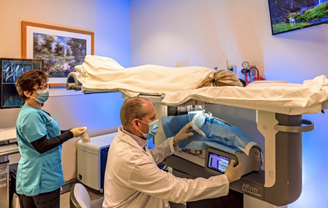 Doctor and nurse with patient during breast imaging procedure