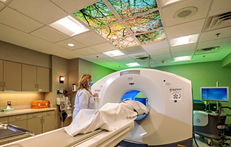 Doctor with patient in CT machine