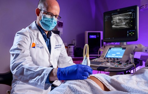 Doctor performing a scan on patient