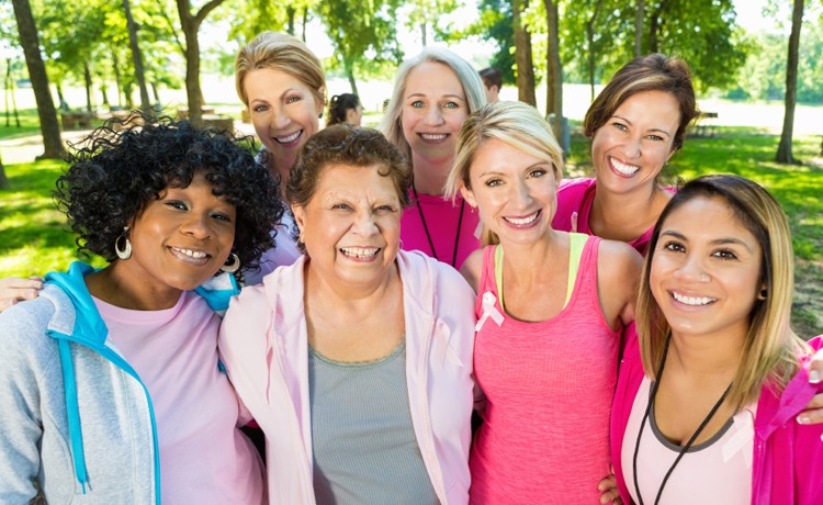 group of women smiling outside