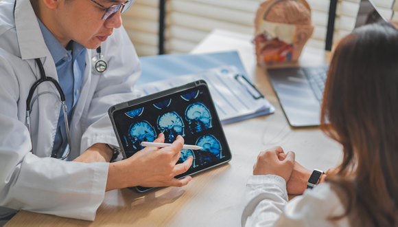 Doctor showing a patient a brain scan.