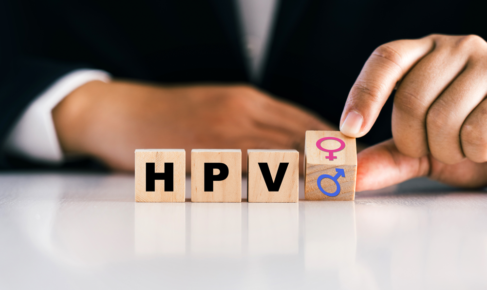 Wooden blocks spelling "HPV" is shown.