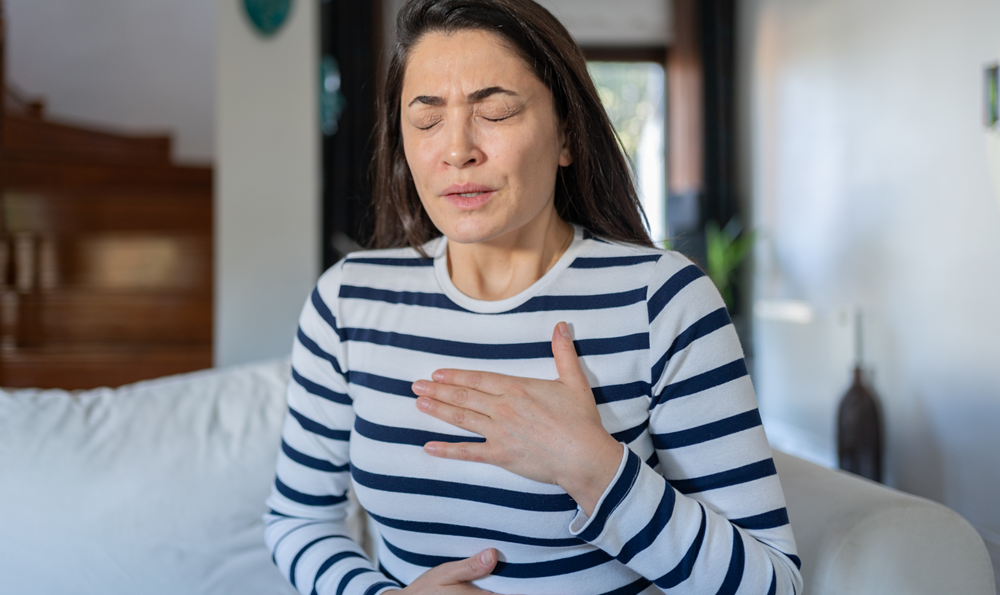 A woman experiencing heartburn
