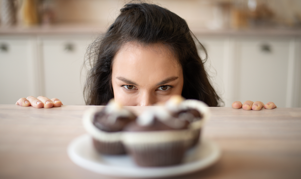 A woman looking at cupcakes
