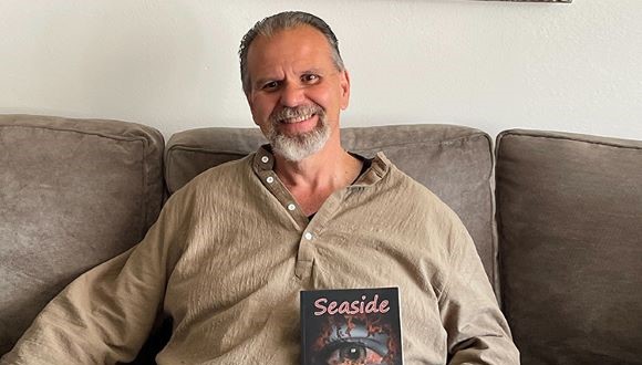 Walter sitting on the couch with a book.