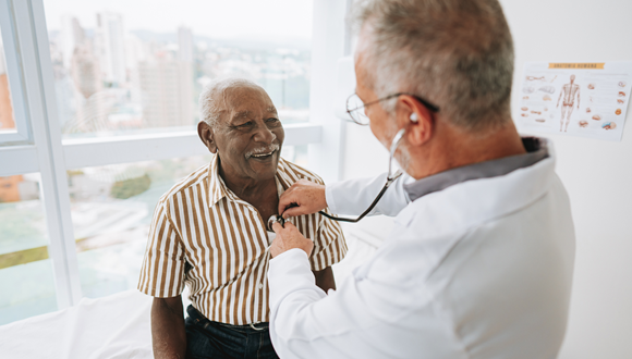 Doctor using a stethoscope on a patient.