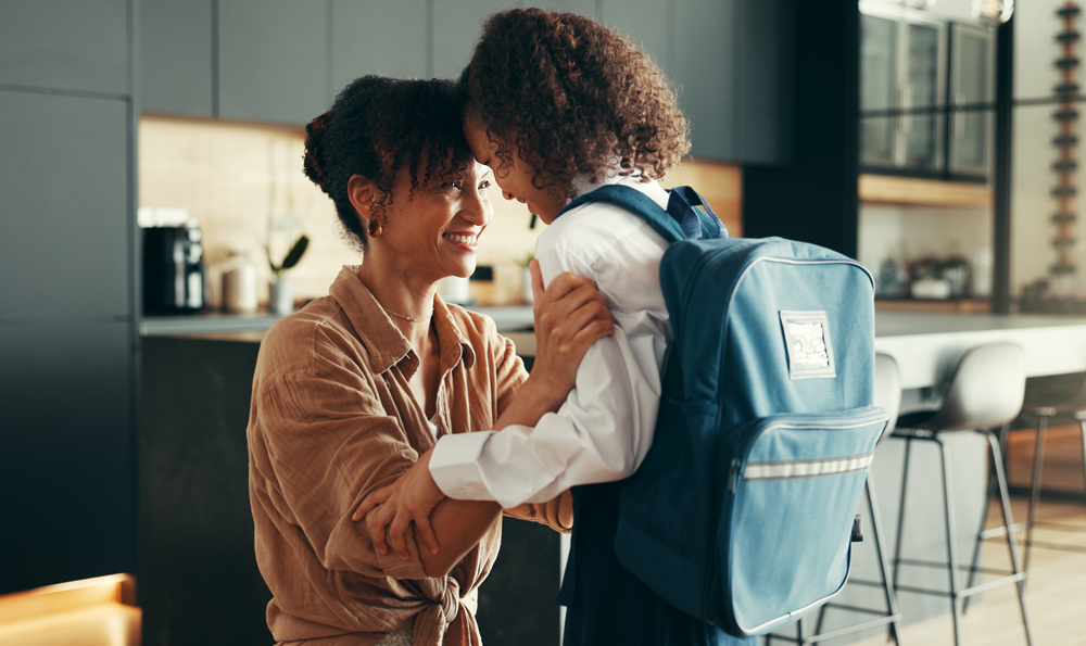 A woman talking to a child at school.