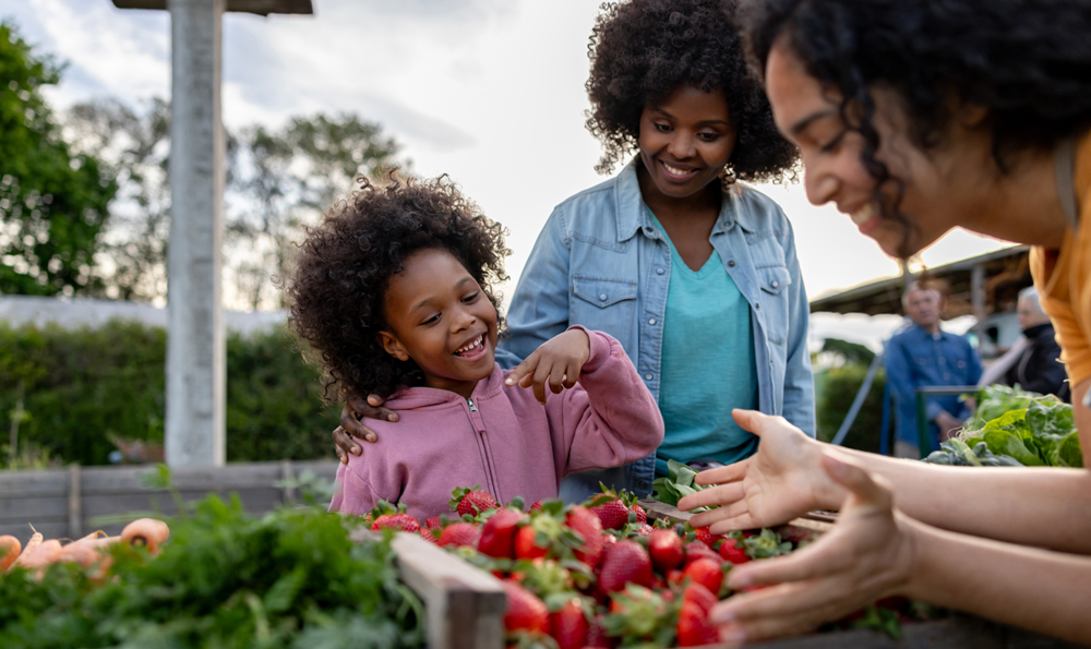 Women eating local produce.