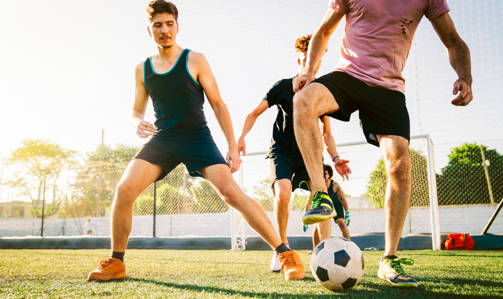 Men playing soccer. 