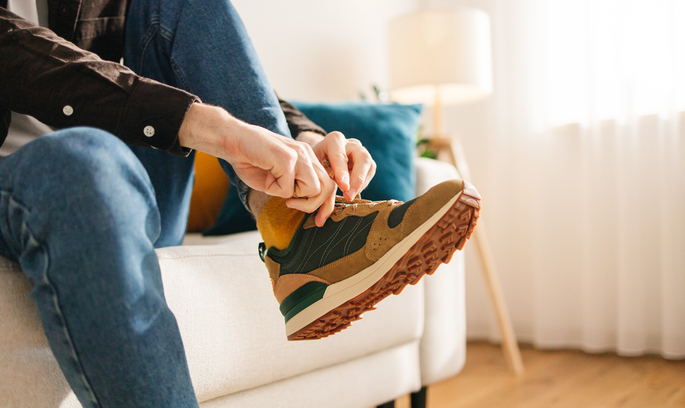 A person putting on a sneaker