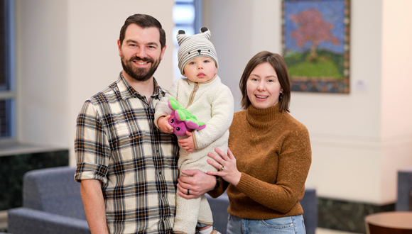 Dana and her husband holding their baby, Michael, is shown. 