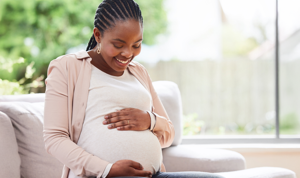 A smiling black pregnant woman