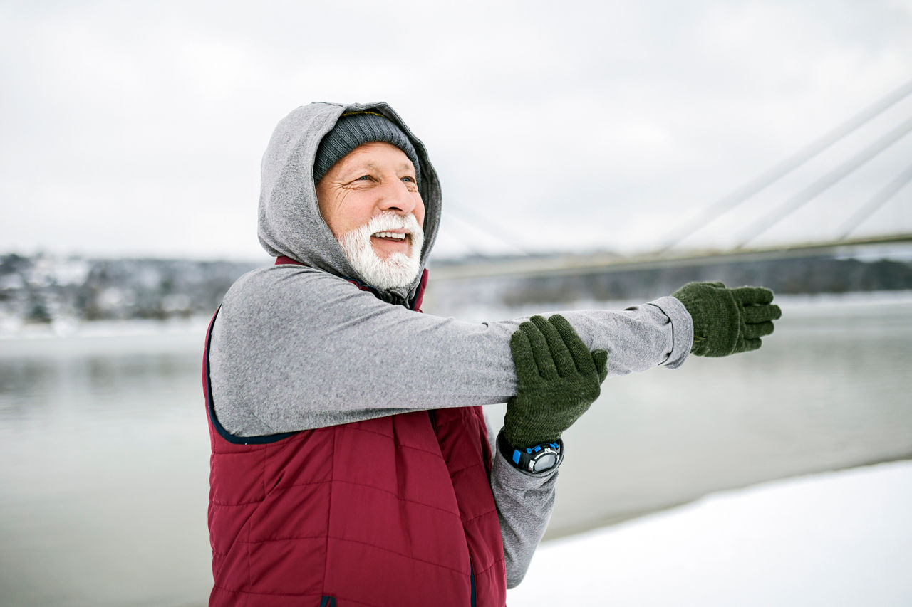 Man stretching outside in the winter