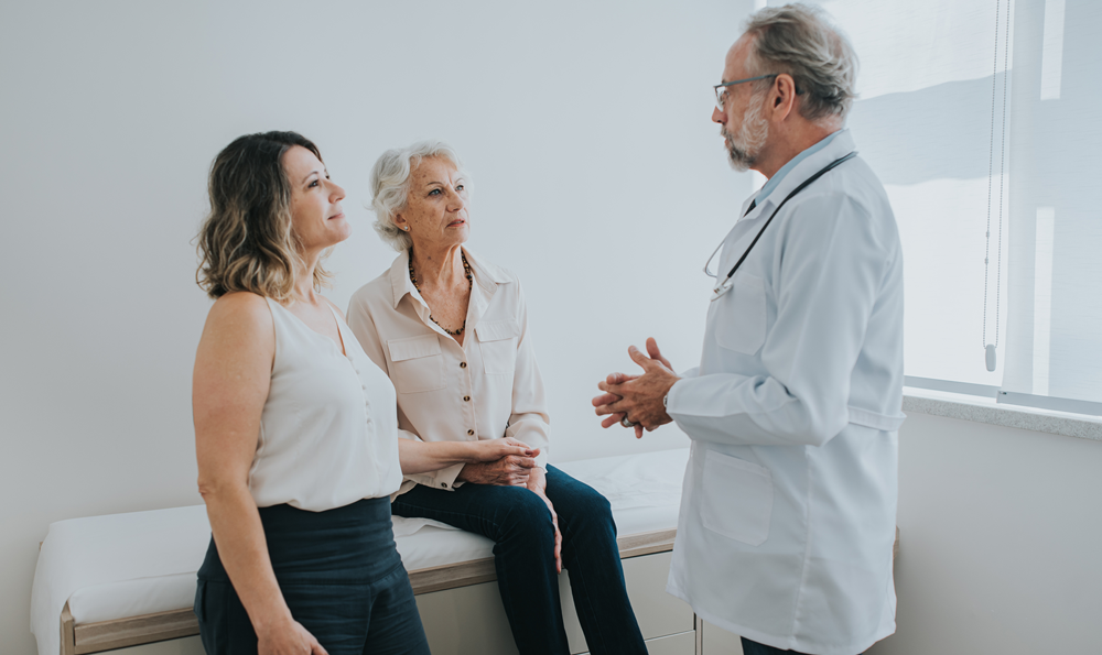 Doctor with patient and caregiver