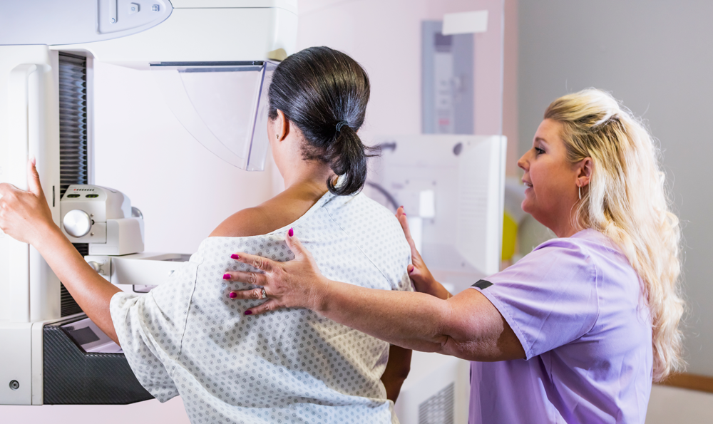 A woman receives a mammogram