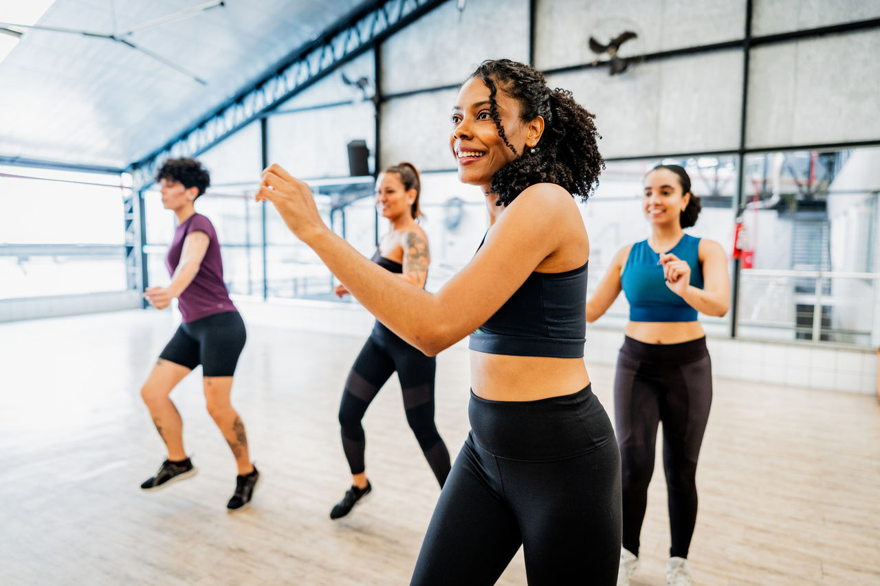 Mid adult woman dancing during dance class at the fitness center